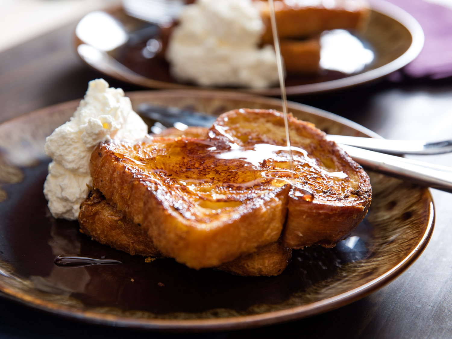 Thick, tender, custardy slices of challah or brioche, perfectly browned and flavored with orange zest, rum, and a trio of spices. This is special-occasion French toast.